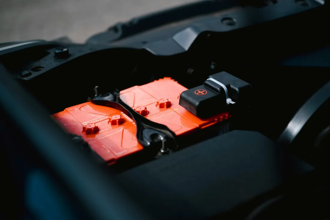 Battery, starter & alternator repair — close-up of a car battery in the engine bay