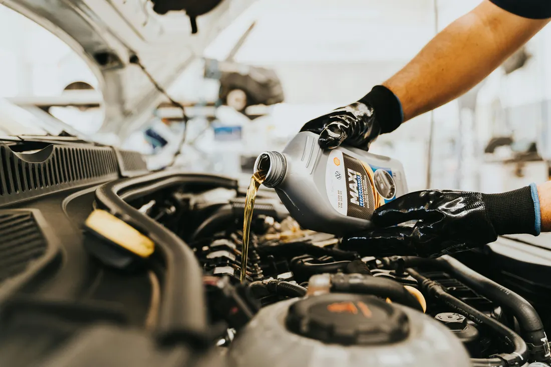 Fluid exchanges — fresh engine oil being poured during a service